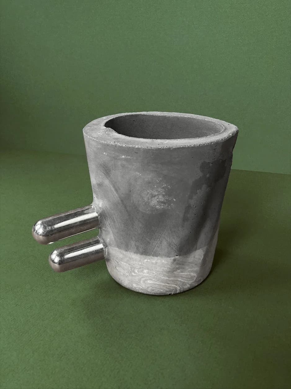 Make It Double — a concrete vessel with two parallel chrome rods, unplanted