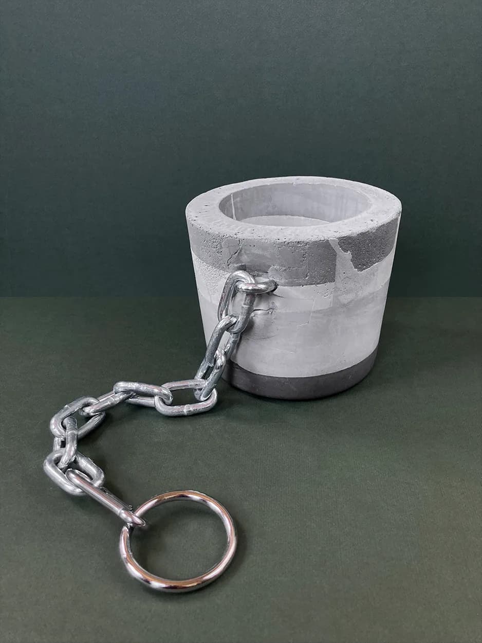 Anyone but You — a concrete vessel with a chain and keyring, unplanted